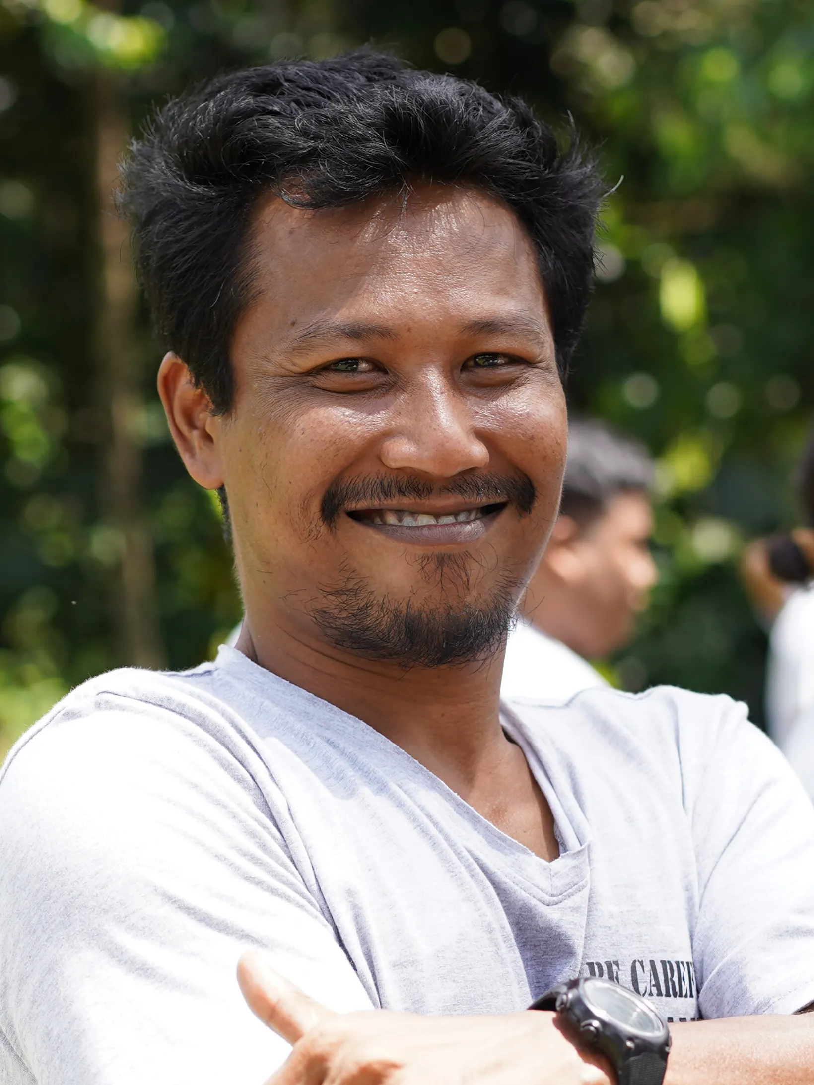 Gaya Ceramic team member smiling outdoors in the garden